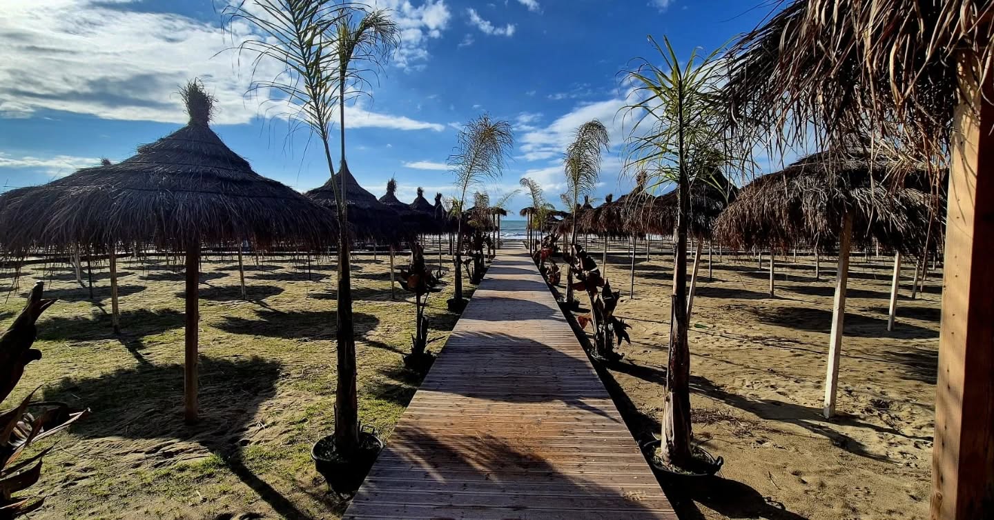 Sandy beach in Golem Albania near hotels where Sleid Rental offers car rental with free delivery